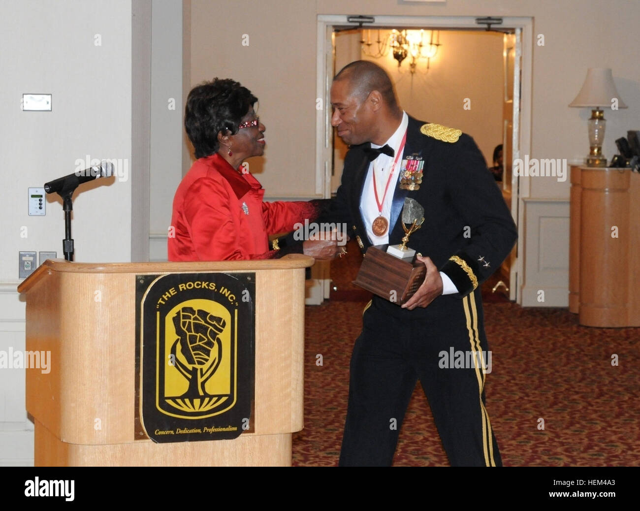 Maj. Gen. Dana J.H. Pittard, 1st Armored Division and Fort Bliss commanding general, receives the 'Rock of the Year' award from retired Brig. Gen Clara Adams-Ender at the 2012 Rocks Spring Formal. The Rocks, Inc. is a 501(c)3 organization whose mission is to mentor officers and cadets. The organization provides more than $30,000 in scholarships to cadets annually. 2012 Rocks National Leadership and Training Conference 120331-A-YZ907-001 Stock Photo