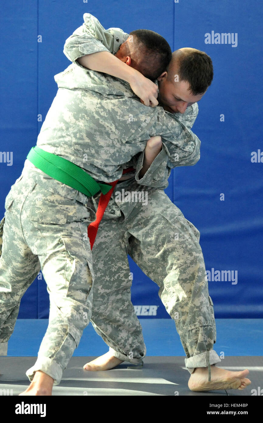 U.S. Army Staff Sgt. Victor Ortiz (red belt) from U.S. Army Garrison Stuttgart and Staff Sgt. Francisco Sandoval (green belt) from U.S. Army Garrison Ansbach compete in a combatives tournament during the Installation Management Command-Europe Best Warrior Competition in the Grafenwoehr Training Area in Grafenwoehr, Germany, April 3, 2012. Staff Sgt. Ortiz lost his hand in an improvised explosive device attack in Iraq 2004. The IMCOM-E Best Warrior Competition identifies the best qualified soldier and non-commissioned officer to represent IMCOM-E in the 2012 Department of the Army Non-commissio Stock Photo