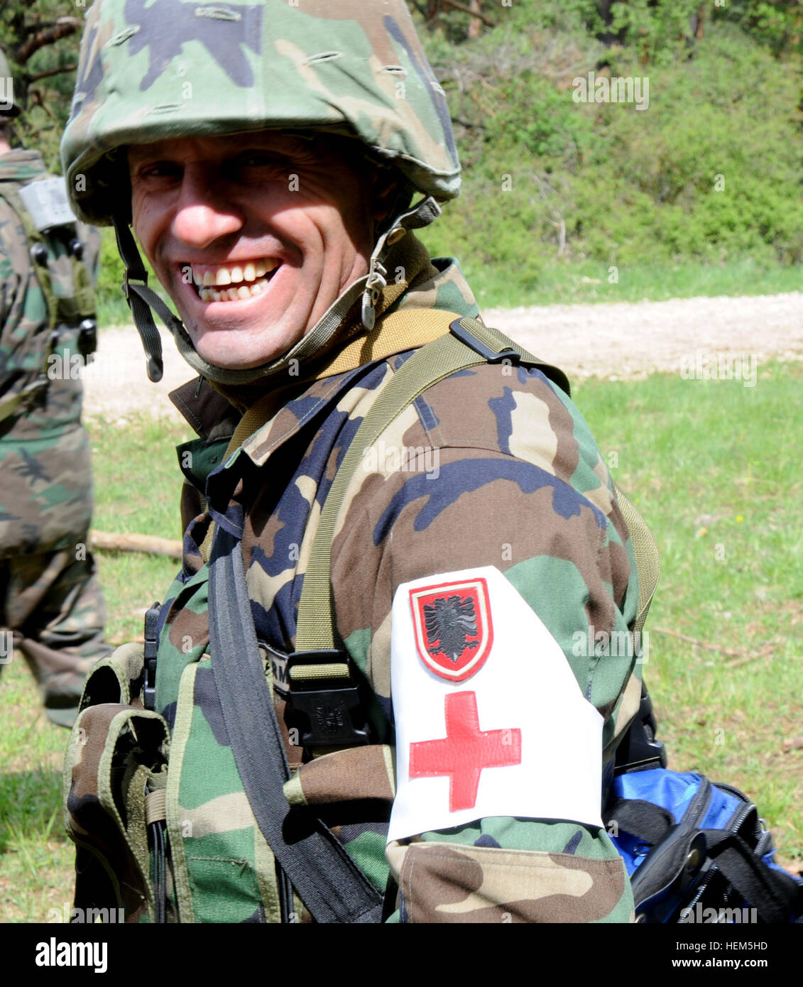 An Albanian soldier, replicating an Afghan National Army soldier, smiles after recieving a compliment during medical evacuation training at the Joint Multinational Readiness Center in Hohenfels, Germany, May 7, 2012.  Operational Mentor Liaison Team XXIII and Police Operational Mentor Liaison Team VII training are designed to prepare teams for deployment to Afghanistan with the ability to train, advise, and enable the Afghan National Security Force in areas such as counter-insurgency, combat advisory, and force enabling support operations.  (U.S. Army photo by Spc. Fredrick J. WIllis Jr./Not R Stock Photo