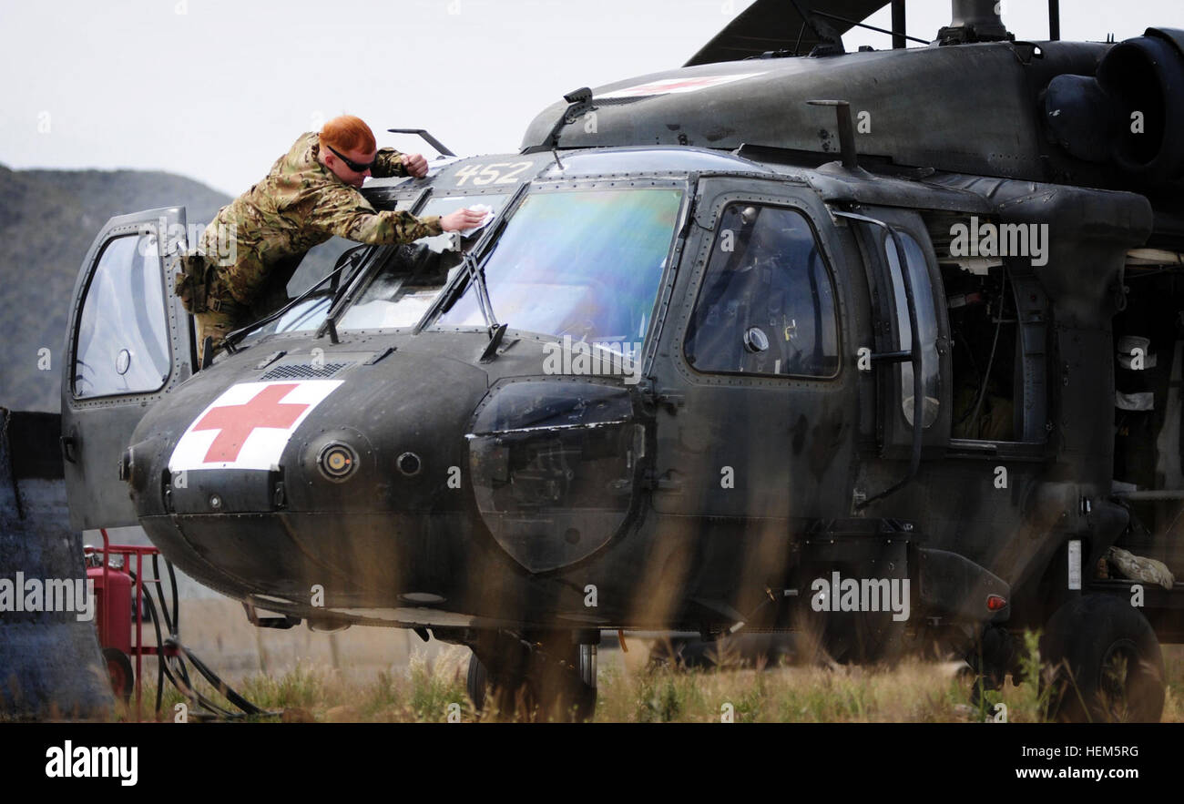 U.S. Army Spc. Mark Jordan, a medevac crew chief from New Albany, Miss., prepares his UH-60 Black Hawk for flight on Forward Operating Base Salerno, Afghanistan, May 9. Valkyrie medevac 580056 Stock Photo