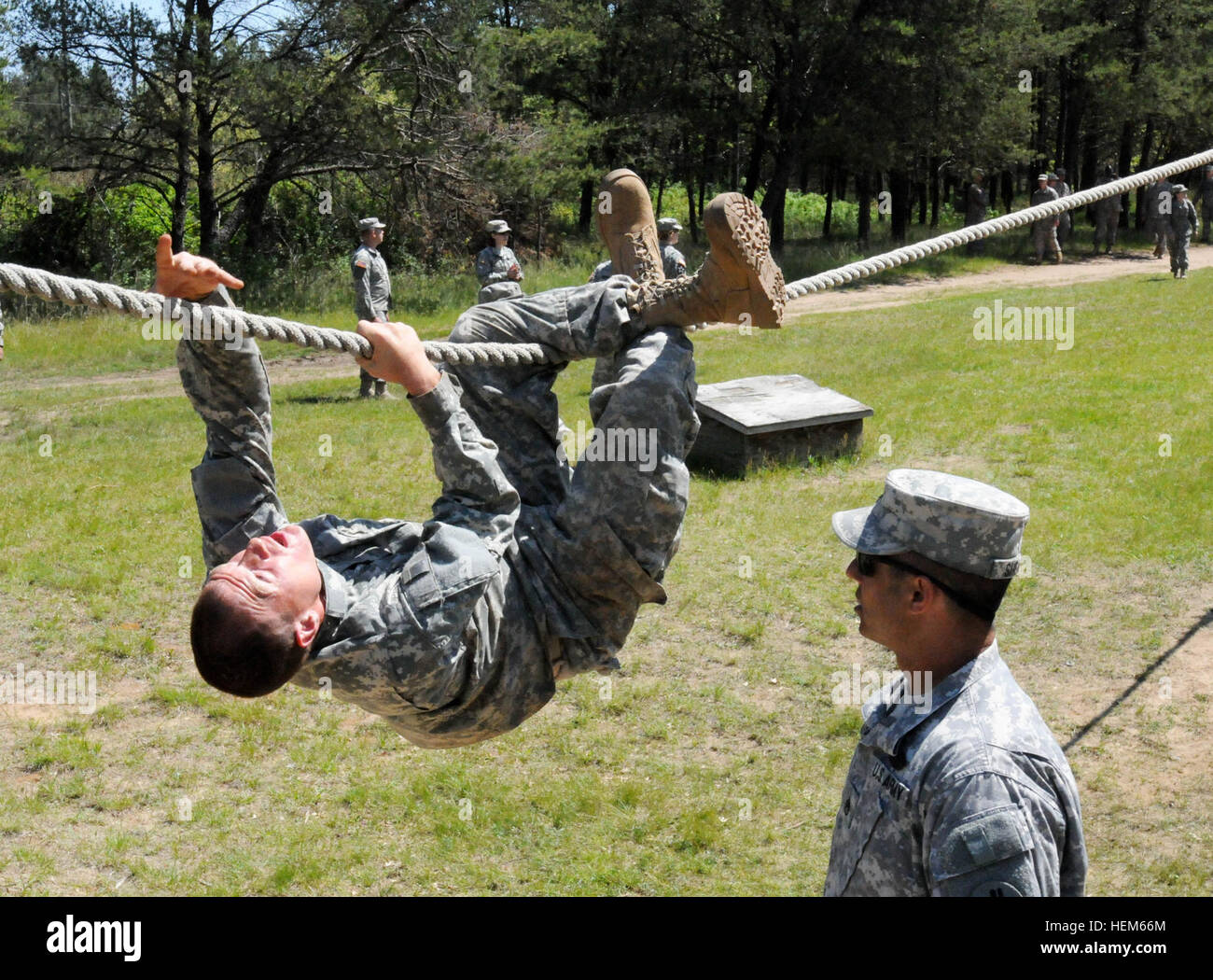 Spc. Kristian Sherrill, 295th Ordnance Company, slides along a rope, May 15, on the confidence course during the Physical Readiness Enhancement Training at Fort McCoy, Wis. The 15-day course included physical training and nutritional education to improve soldiers' Army Physical Fitness Test scores and weight control. Becoming mentally and physically tough, PRET teaches, motivates Soldiers to be fit 585440 Stock Photo