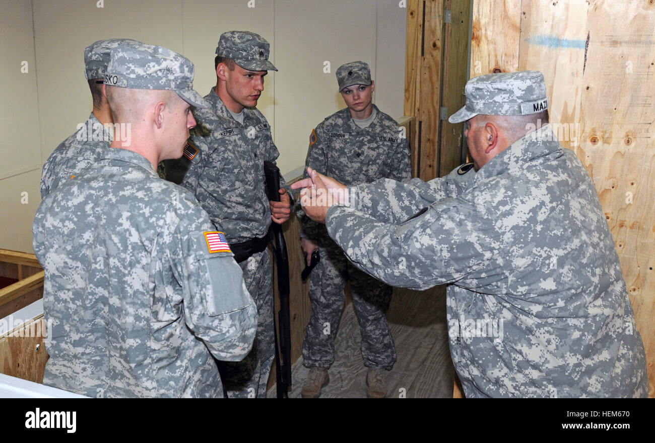 Maj. David Mazi, Area Support Team Balkans director of security, plans and operations, right, instructs a group of military policemen during an active shooter response training exercise at Camp Bondsteel, May 16, 2012. The training is part of a Department of Defense program instituted after the 2009 Fort Hood shooting. MPs hone active shooter response 120516-A-AC723-053 Stock Photo