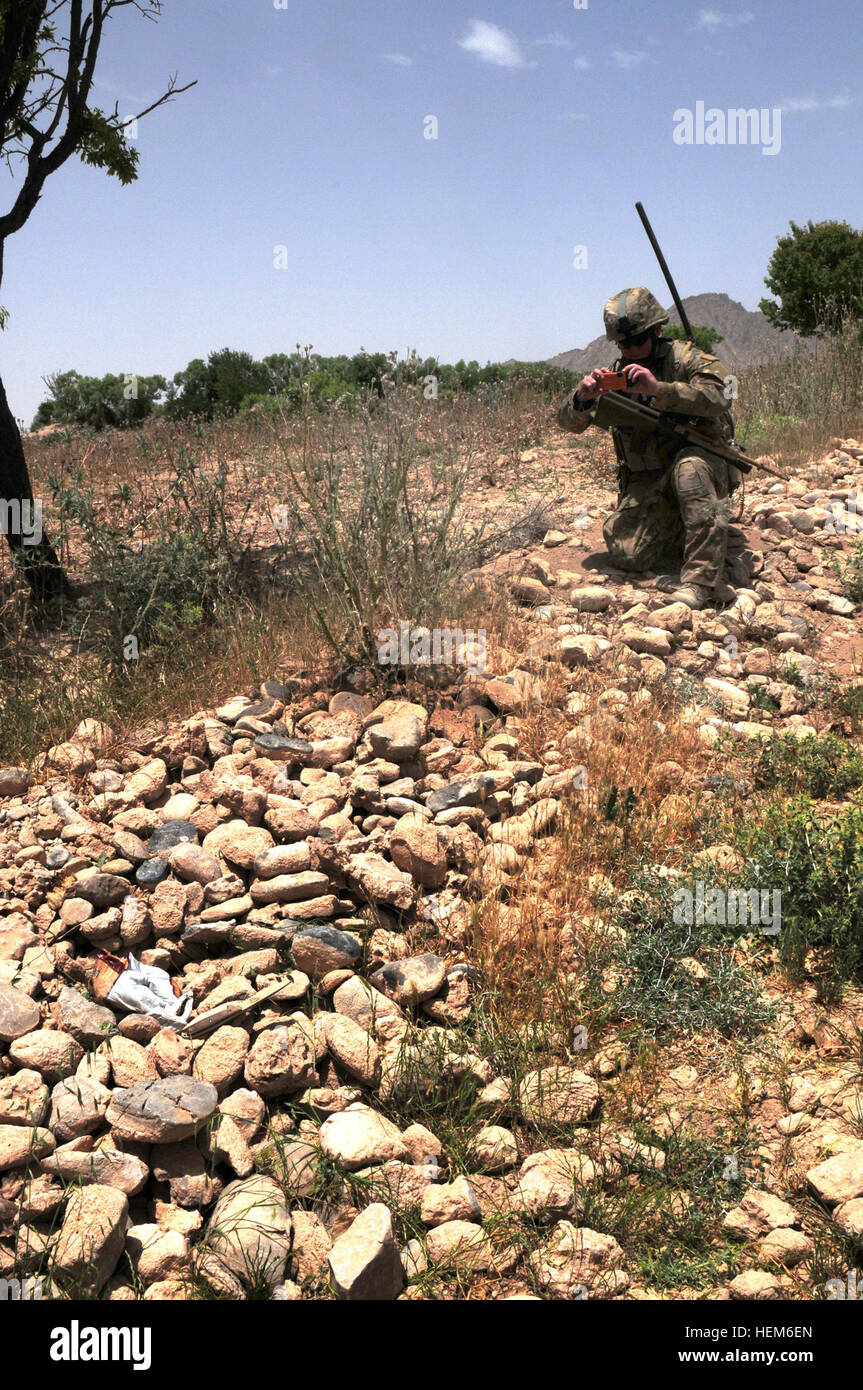 Australian Cpl. Brendon James Hall, search commander of the Other Government Agency Platoon, Provincial Recovery Team, photographs a bag of chemicals used to make home made explosives during a route clearance mission in Uruzgan province, Afghanistan, May 29, 2012. The bag contained ammonium nitrate mixed with aluminum powder, both common ingredients used in improvised explosive devices. Aussie soldier keeps his mates safe till they go home 120529-A-GM826-067 Stock Photo