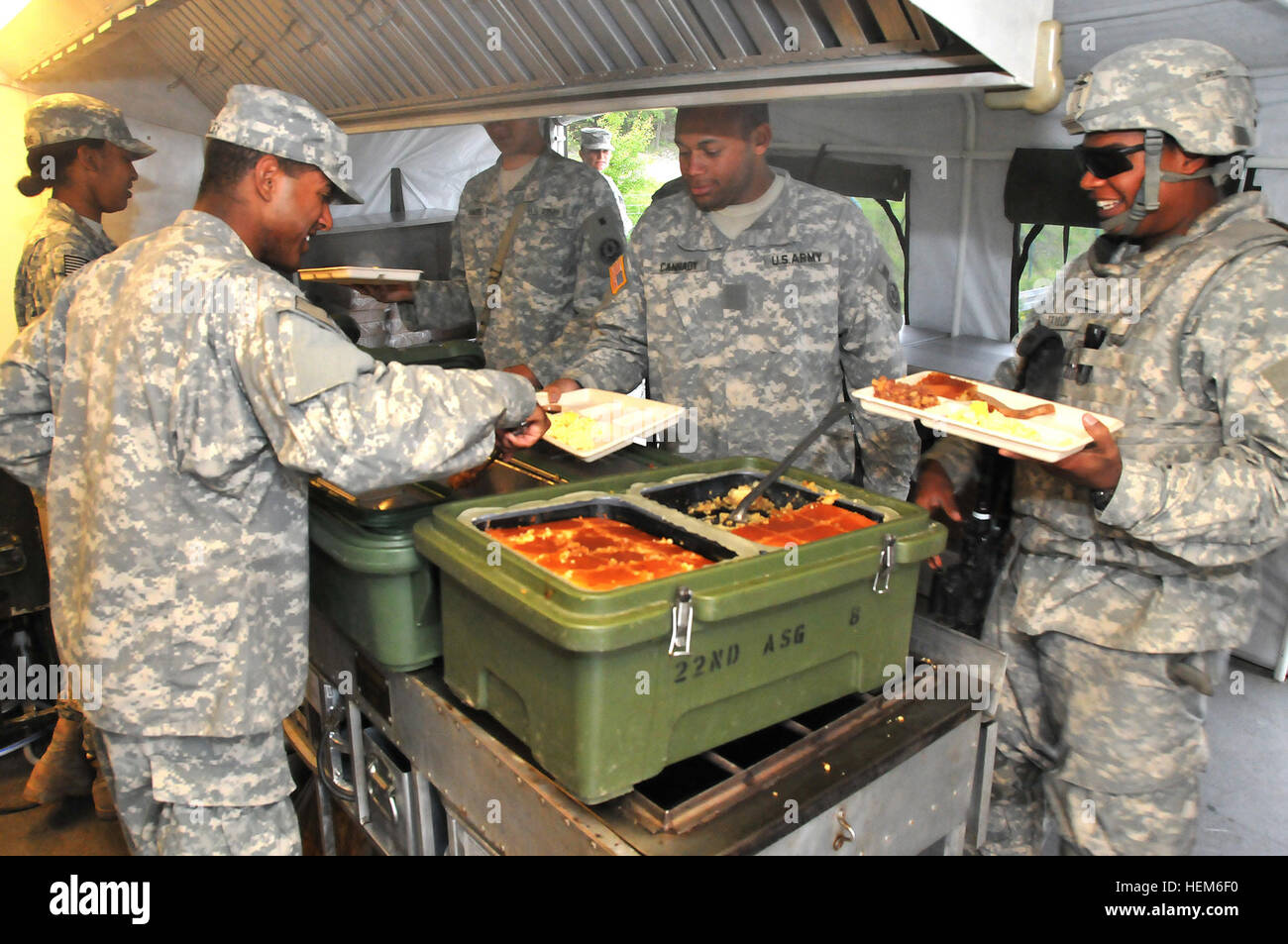U.S. Army soldiers (left) from Field Feeding Team 4, Regimental Support  Squadron (RSS), 2nd Cavalry Regiment (2CR) Rose Barracks, Germany serve  breakfast to U.S. Army soldiers assigned to “Mad Dog “ Troop,