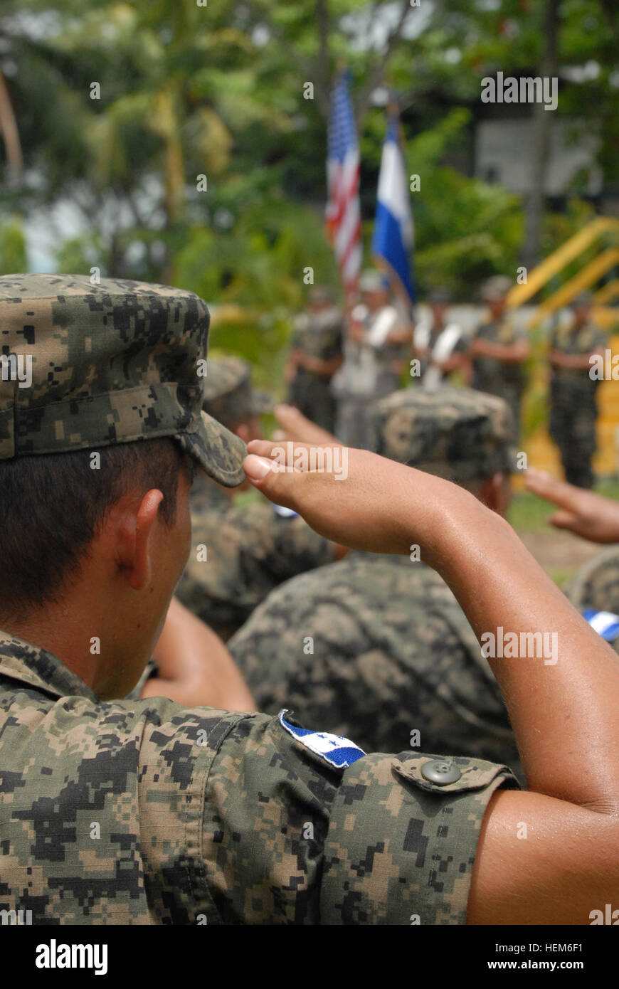 Honduran soldiers salute during the playing of the national anthems of the U.S. and Honduras during the closing ceremony for Beyond the Horizon Honduras 2012 held at Forward Operating Base Naco, Honduras, June 26. BTH Honduras is an Army South-led exercise that deploys military engineers and medical professionals to Honduras for training, while providing services to rural communities. Honduran soldier salutes during BTH-Honduras 2012 Closing Ceremony 120626-A-PP526-004 Stock Photo