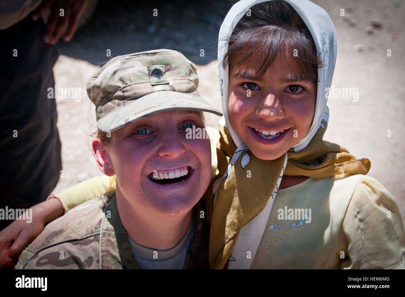 PARWAN PROVINCE, Afghanistan -- U.S. Army Spc. Helen Jeschow, a native of Greensborough, N.C., hugs little Sode Jan, an Afghan girl she has befriended over the course of several months of volunteer work at the Egyptian Field Hospital on Bagram Air Field.  Jeschow is an information support operations specialist with the 340th Military Information Support Operations unit, Task Force Tsunami. (U.S. Army photo by Sgt. Ken Scar, 7th Mobile Public Affairs Detachment) Greensboro, NC, native serves with big heart, helps Afghan children 120603-A-ZU930-003 Stock Photo