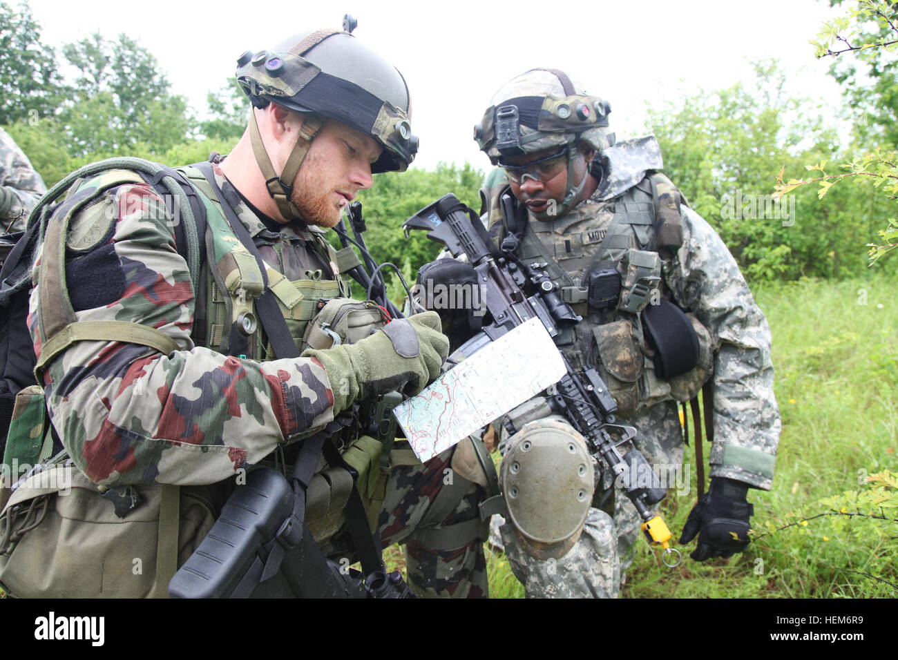 A Slovenian soldier surveys a map as he and forces from U.S. Army Europe’s 2nd Cavalry Regiment plan an assault as part of a field training exercise during the Immediate Response 2012 (IR12) training event held in Slunj, Croatia on Tuesday, June 5, 2012.  IR12 is a multinational tactical field training exercise that will involve more than 700 personnel primarily from the U.S. Army Europe’s 2nd Cavalry Regiment and Croatian armed forces, with contingents from Albania, Bosnia-Herzegovina, Montenegro and Slovenia. Macedonia and Serbia will send observers to the exercise.  The exercise is a part o Stock Photo