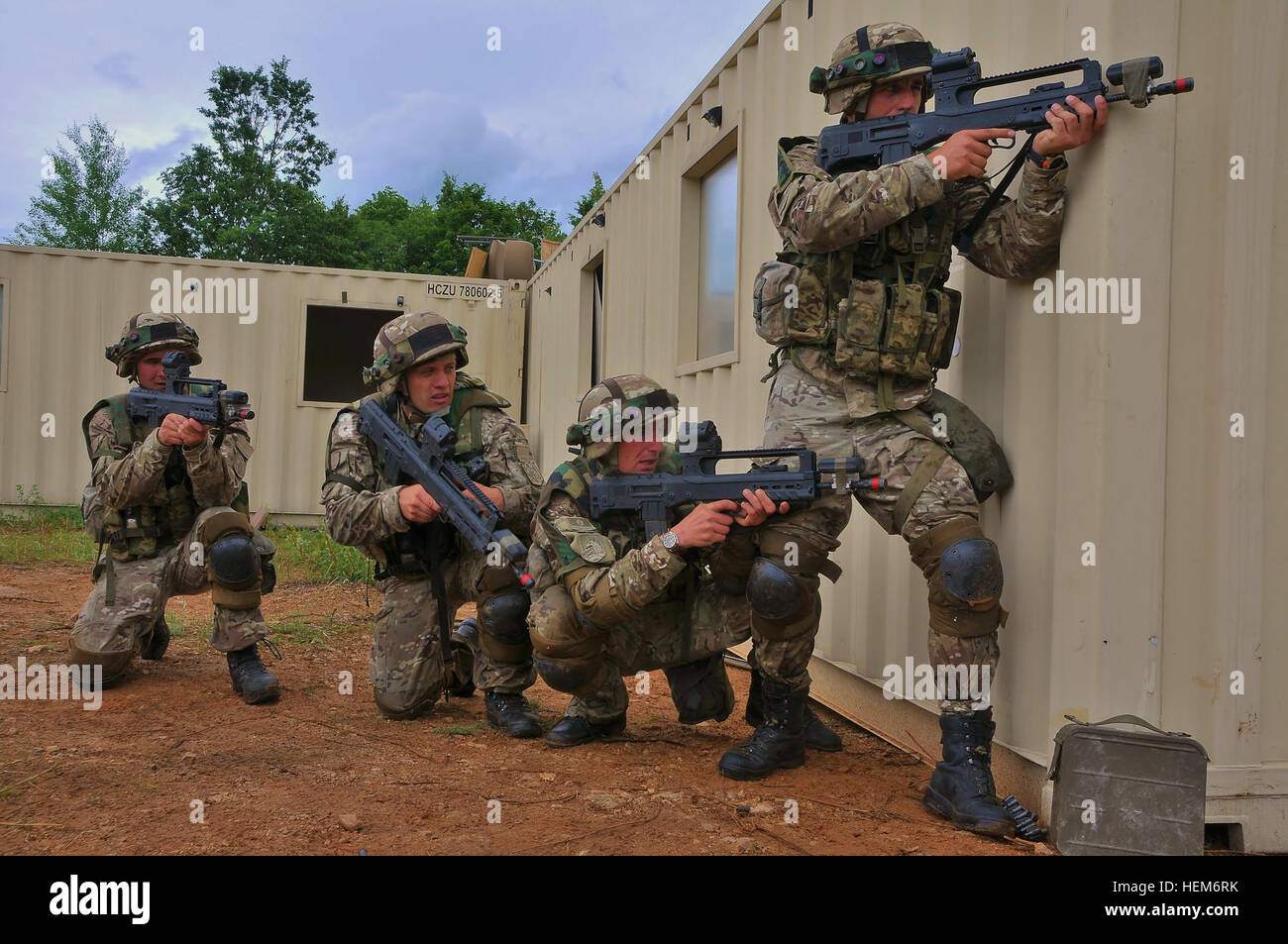 Montenegrin Army soldiers of 1st platoon return fire around the coner of a building at the opposing force during the Immediate Response 2012 (IR12) training event held in Slunj, Croatia on June 5,2012 IR12 is a multinational tactical field training exercise that will involve more than 700 personnel primarily from the U.S. Army EuropeÕs 2nd Cavalry Regiment and Croatian armed forces, with contingents from Albania, Bosnia-Herzegovina, Montenegro and Slovenia. Macedonia and Serbia will send observers to the exercise.  The exercise is a part of USEUCOM's joint training and exercise program designe Stock Photo