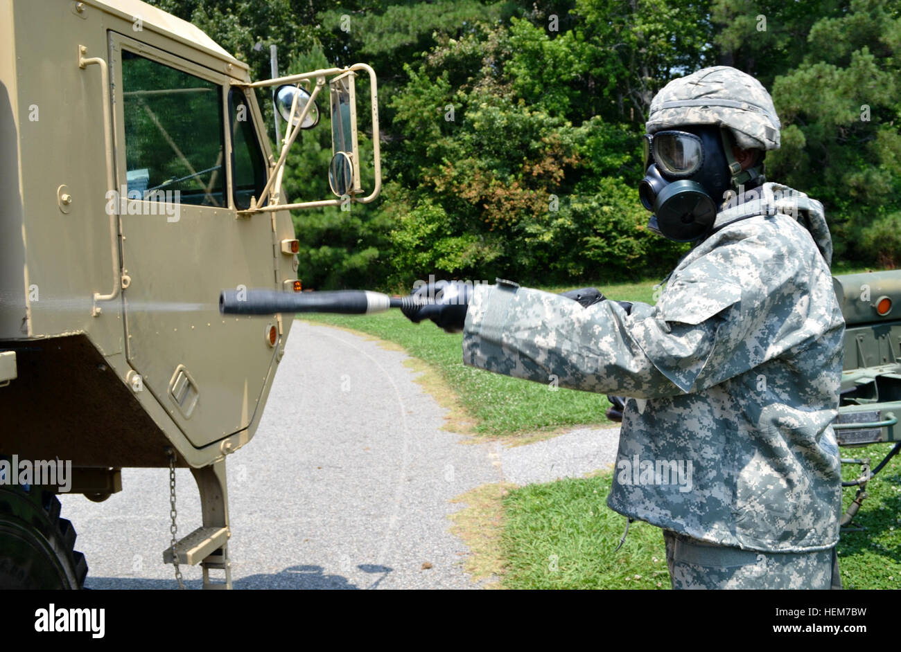 Spc. Tremayne Miller, a soldier assigned to the 567th Inland Cargo Transfer Company, rinses off a palletized load system after it has been decontaminated during a company level nuclear, biological and chemical exercise at Fort Eustis, June 19. Spraying down the PLS 120619-A-UV471-957 Stock Photo