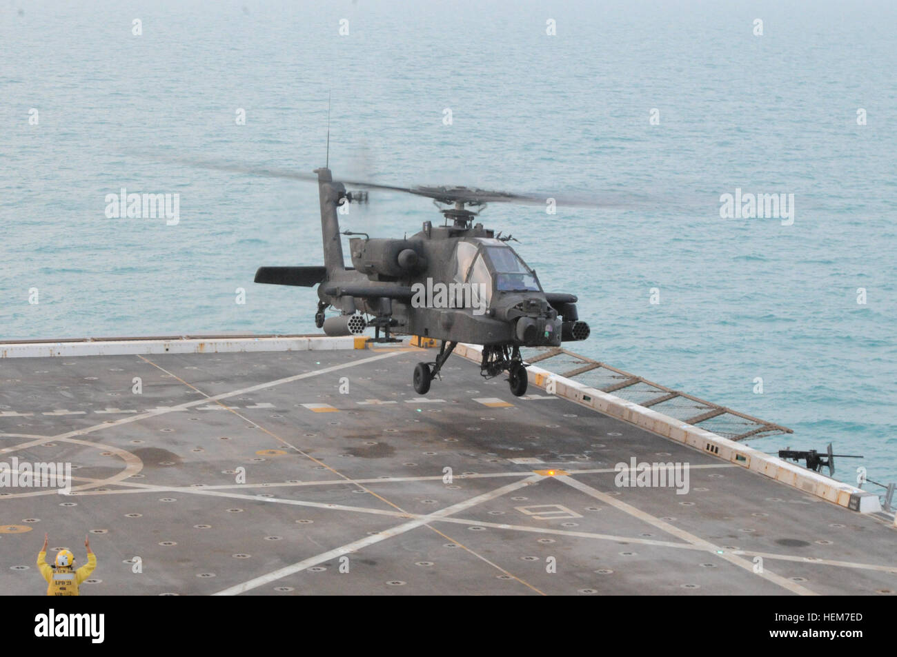 The AH-64D Longbow Apache is seen taking off from the deck of the USS New York in the Persian Gulf.  3-159th Attack Reconnaissance Battalion is cooperating with the Naval vessel to train their pilots in proper overwater flight and landing techniques. - Photo by SPC Tom Johnson Spartan Shield 120622-A-ZV382-104 Stock Photo
