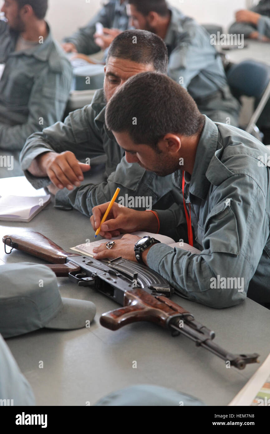 An Afghan Uniform Police recruit takes notes about the AK-47 assault rifle during a class at Forward Operating Base Shank, Logar province, Afghanistan, July 2, 2012. AUP AK-47 class 120702-A-BZ540-029 Stock Photo