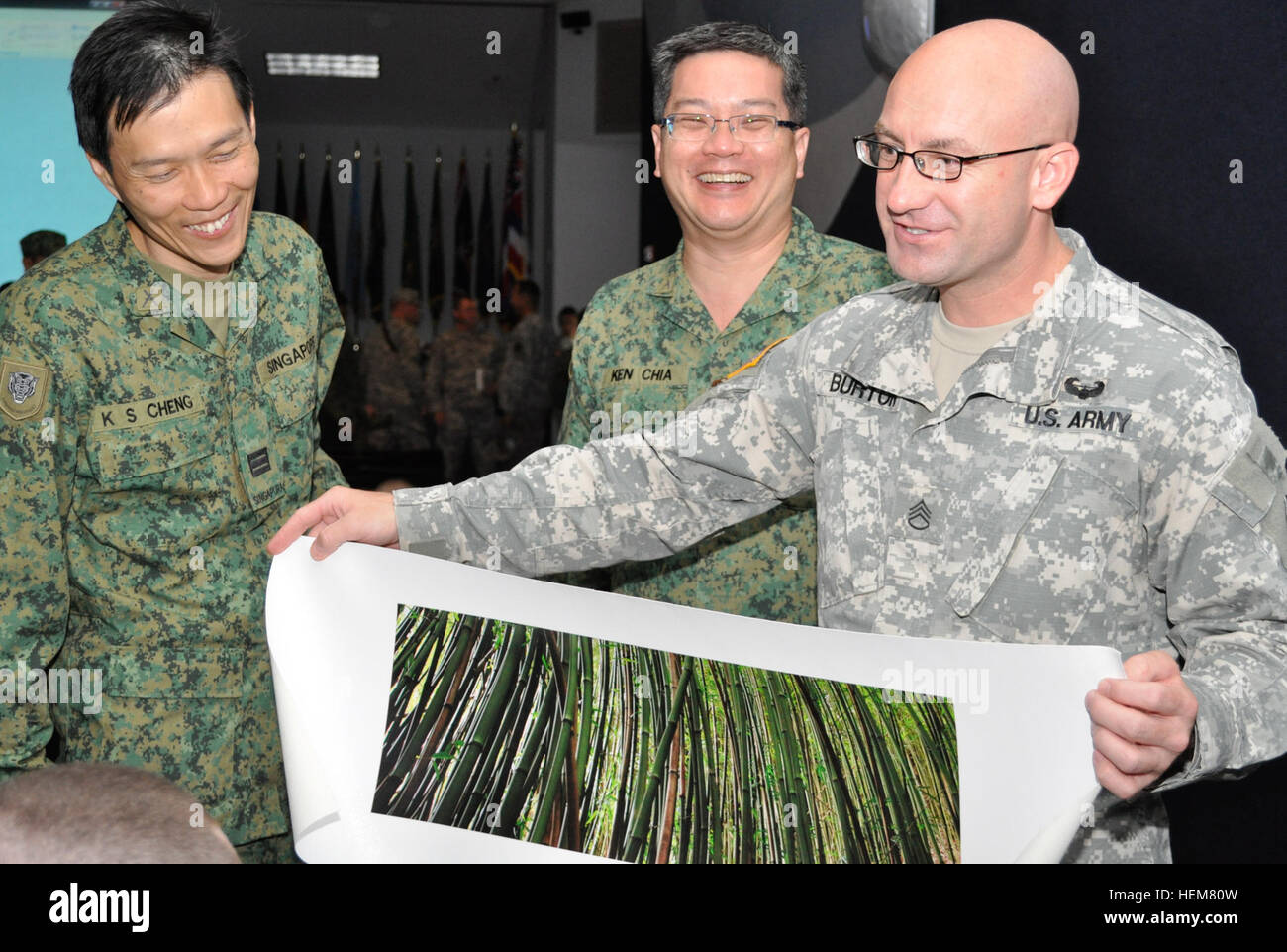 Staff Sgt. Tim Burton, Hawaii Army Reserve, shares his civilian work as a  photographer with members of the Singapore Armed Forces during Exercise  Tiger Balm held at Hawaii Army National Guard Regional