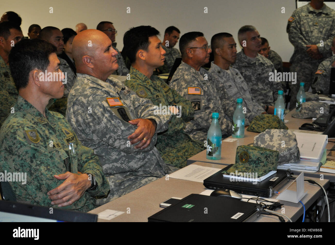 Maj. Gen. Joseph Chaves, Deputy Commanding General, United States Army Pacific,  Brig. Gen. Gary Hara, Hawaii Army National Guard commander and Brig. Gen. Perry Lim, 3 Division, Singapore Armed Forces commander , receive a briefing of activities and training points during Exercise Tiger Balm 2012 held at the Hawaii National Guard Regional Training Institute, in Waimanalo, Hawaii, July 18. Generals visit National Guard Exercise Tiger Balm 2012 628774 Stock Photo