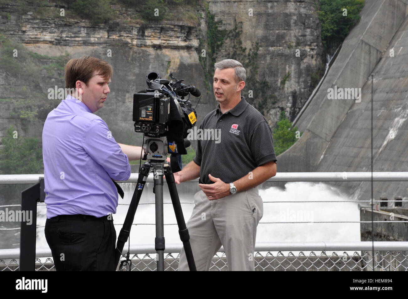 Tim Dunn, right, operations project manager for the mid-Cumberland area, U.S. Army Corps of Engineers Nashville District, explains why the Corps is having guided tours of the Center Hill Lake power plant during an interview with NBC News Channel 4 reporter and videographer Forrest Sanders July 21, 2012. Center Hill Lake open house, power plant tours draw young, elderly visitors 120721-A-HL948-004 Stock Photo