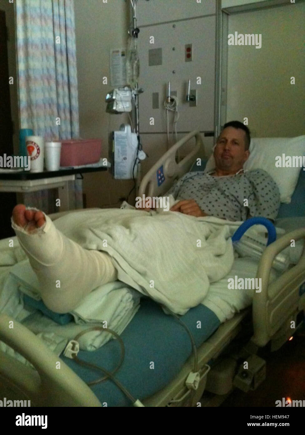 Army Sgt. Maj. Michael L. Van Engen, with the 1-501st Infantry Regiment, 4th Brigade Combat Team (Airborne), 25th Infantry Division, rests in a hospital bed after having foot surgery to remove an exterior fixator which was used to support and hold his foot secure while his bones healed August 2012 at the 673d Medical Group Hospital at Joint Base Elmendorf-Richardson, Alaska. Van Engen has endured several surgeries since being shot by enemy insurgents June 1, 2012, in Afghanistan. (Courtesy Photo) Battle-wounded Army sergeant major%%%%%%%%E2%%%%%%%%80%%%%%%%%99s road to recovery 120817-A-AA000- Stock Photo