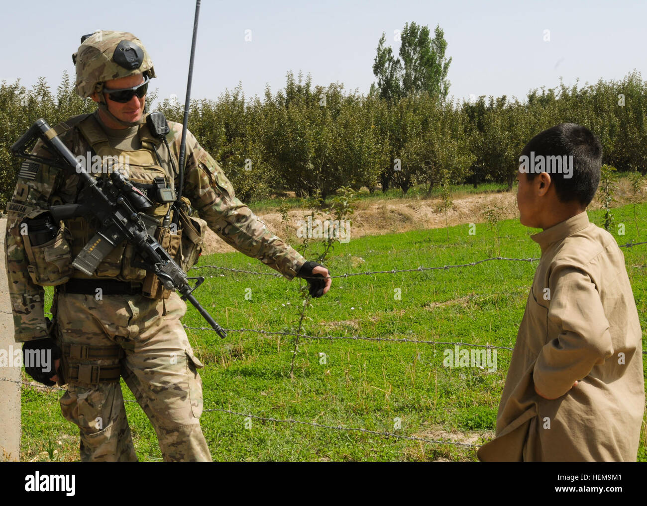 U.S. Army 1st Lt. Joshua McMillan, the platoon leader for 2nd Platoon, Company D, 1st Battalion, 143rd Infantry Regiment (Airborne), 36th Infantry Division, talks with an Afghan boy during a mission near the village of Shakar Khel, Gardez district, Sept. 5, 2012. McMillan and his platoon are the security element attached to the Paktiya Provincial Reconstruction Team, to ensure the safety of the PRT members as they meet with local leaders and farmers. Back to the basics, ADT visits tree nurseries to assess progress 120905-A-GH622-121 Stock Photo