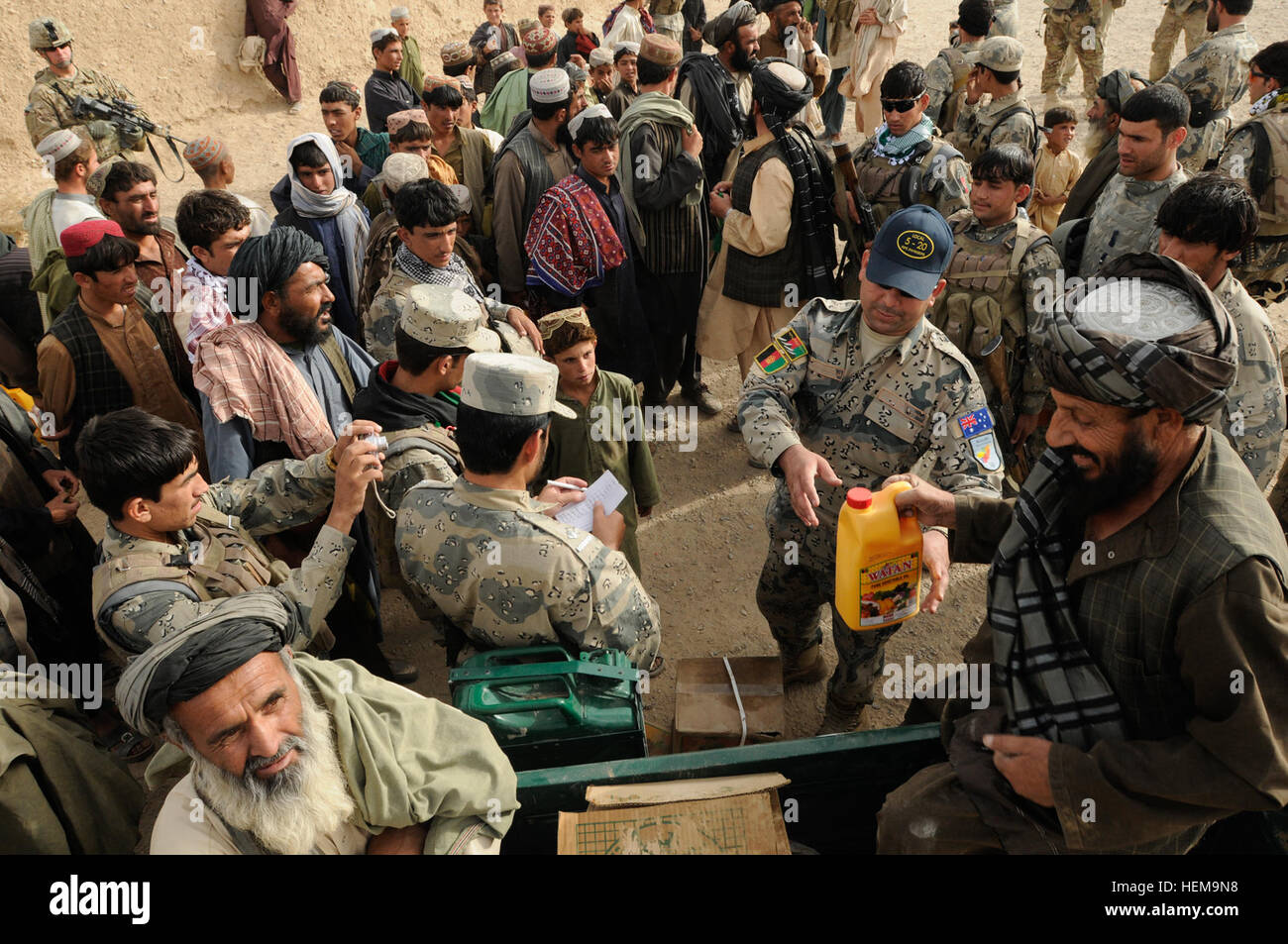 Afghan Lt. Col. Haji Janan, commander of the quick reaction force of the 3rd Zone Afghan Border Police, hands out humanitarian aid during Operation Southern Strike III in the village of Spin Kariz, Spin Boldak district, Kandahar province, Afghanistan, Sept. 6, 2012. The operation focused on dislocating the enemy from the local populations and connecting the district leadership with outlying villages. Southern Strike III takes swing at enemy forces, supplies 120906-A-DL064-599 Stock Photo