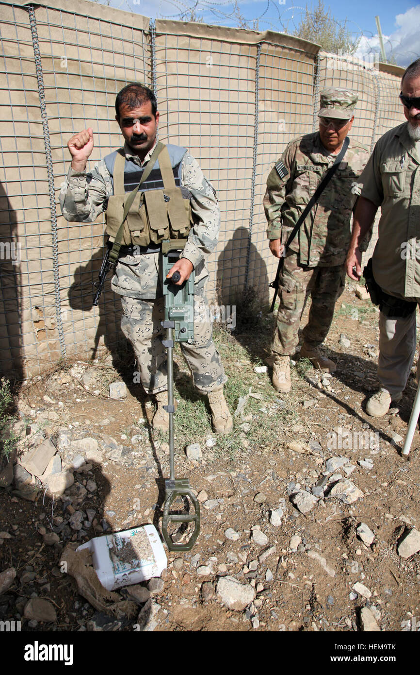 An Afghan Border Police (ABP) officer holds up his hand to indicate he has possibly located an improvised explosive device (IED) on the IED training lane on Combat Outpost Bowri Tana, Khost province, Afghanistan, Sept. 9, 2012. The ABP are trained to locate the IEDs so Explosive Ordnance Disposal will be able to safely remove the threat. (U.S. Army photo by Sgt. Kimberly Trumbull/Released) IED training lane 120909-A-PO167-135 Stock Photo