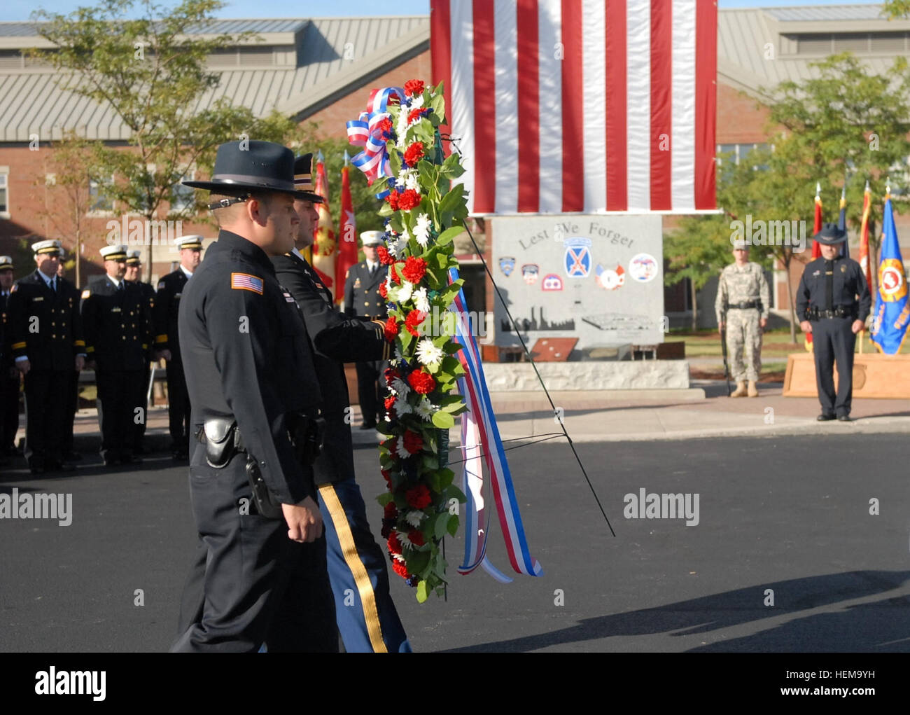 Members of Fort Drum's emergency services teams carry a wreath during