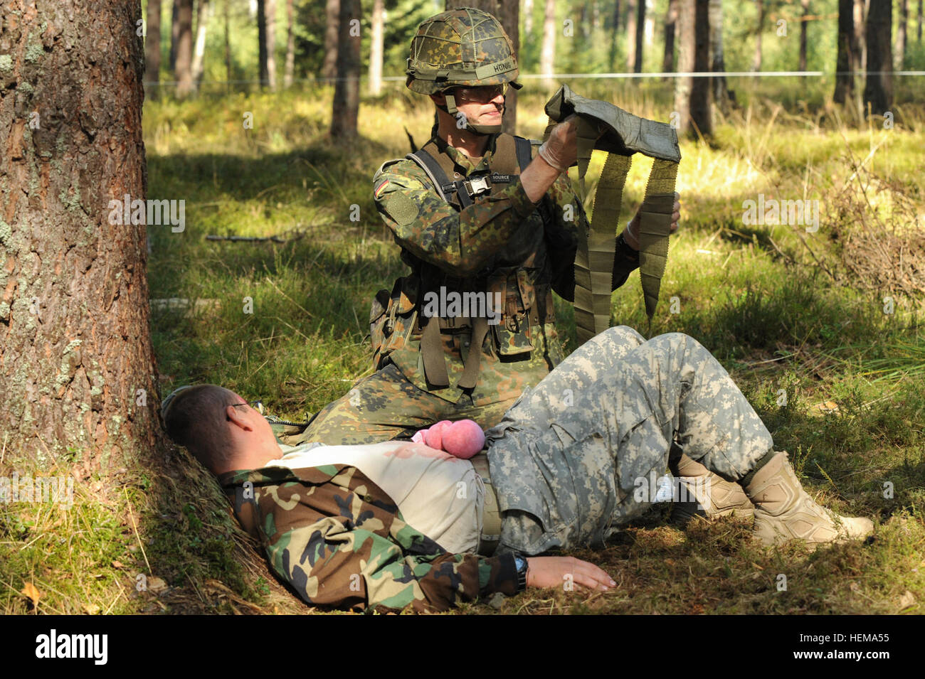 Lt. Lars Hoenig, a German Army soldier, applies a field dressing to an