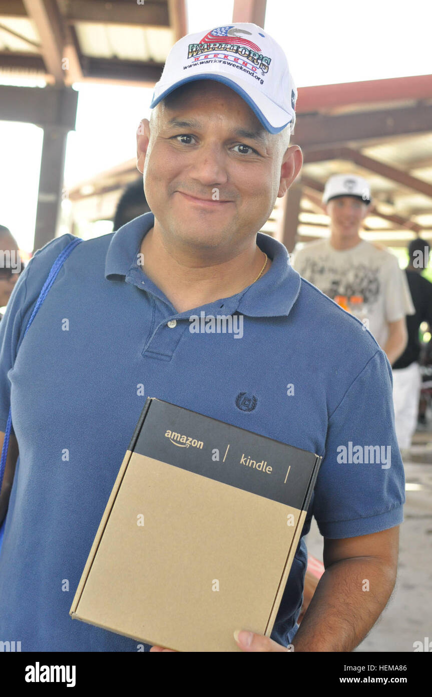 Sgt. Mejia Maximiliano, Warrior Transition Battalion, won the raffle drawing for a Kindle notebook during the BOSS Bash hosted by the Better Opportunities for Single Soldiers at Biggs Park, Sept. 21, 2012. Maximiliano, a native of a native of Harlingen, Texas, is one of more than 300 single soldiers to attend the bash, which featured prizes, mechanical bull riding, free pizza, flag football, video games, and a live D.J. BOSS Bash 120921-A-WO769-212 Stock Photo