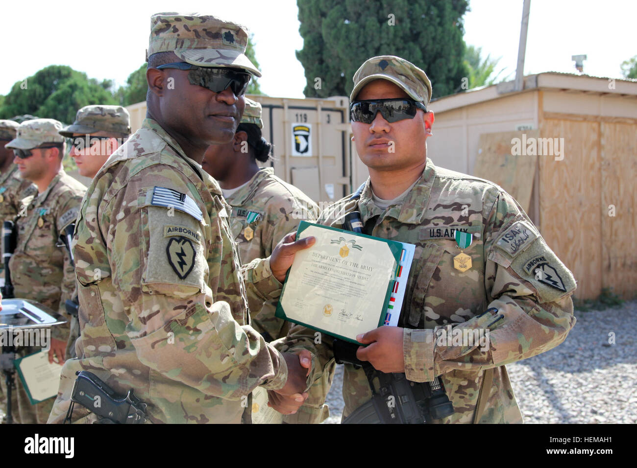 U.S. Army Spc. Yiftheg with 425th Brigade Special Troops Battalion (Airborne), Task Force 4-25, is awarded the Army Commendation Medal by U.S. Army Lt. Col. Frank Smith, battalion commander for 425th Brigade Special Troops Battalion (Airborne), on Forward Operating Base Salerno, Khost province, Afghanistan, Sept. 29, 2012. Award ceremony 120929-A-PO167-108 Stock Photo
