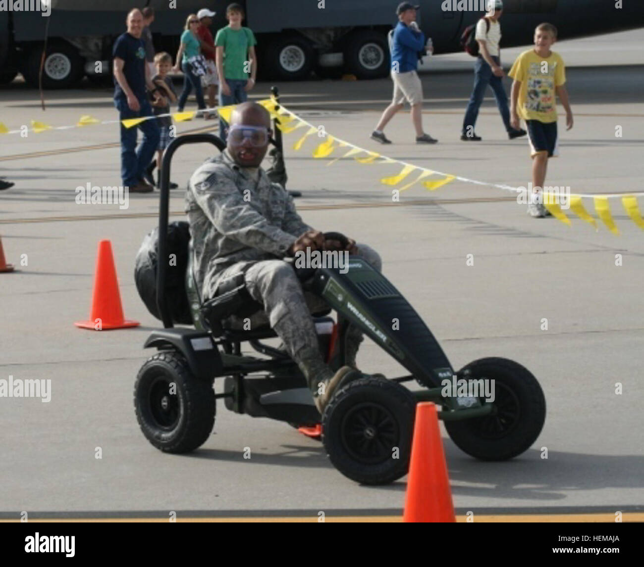 An airman tries out the pedal car obstacle course while wearing goggles that impair vision. The activity demonstrated the effects of alcohol on the body and encouraged people not to drink alcohol while boating. It was one of many interactive and educational activities that were a part of the U.S. Army Corps of Engineers Southwestern Division's water safety event at the McConnell Air Force Base Air Show and Open House Sept. 29 and 30 in Wichita, Kan. Taking water safety to the troops 120930-A-CE999-312 Stock Photo