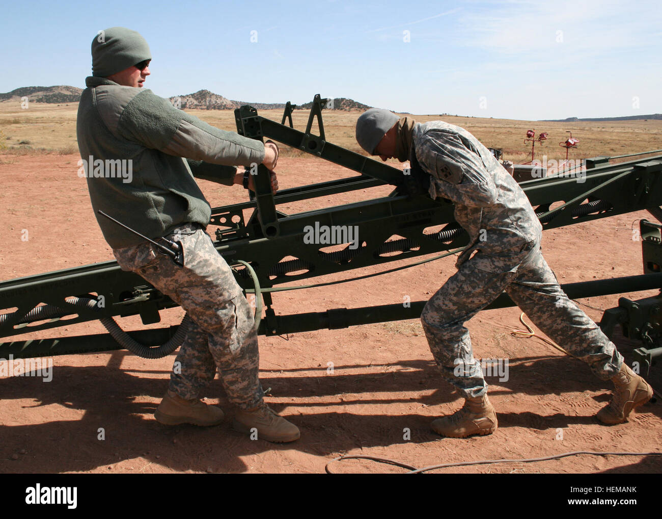 Sgt. Jacob Schmitt, unmanned aircraft systems repairer, and Spc. Nolan Barr, unmanned aerial vehicle operator, both with Company A, 2nd Special Troops Battalion, 2nd Brigade Combat Team, 4th Infantry Division, reset the launching shuttle at Camp Red Devil, Oct. 4, 2012. The shuttle propels the Unmanned Aerial Vehicles then stops short forcing the UAV into flight. After the UAV is launched the shuttle must be set back to the starting position at the base. Reset 121004-A-VX278-005 Stock Photo