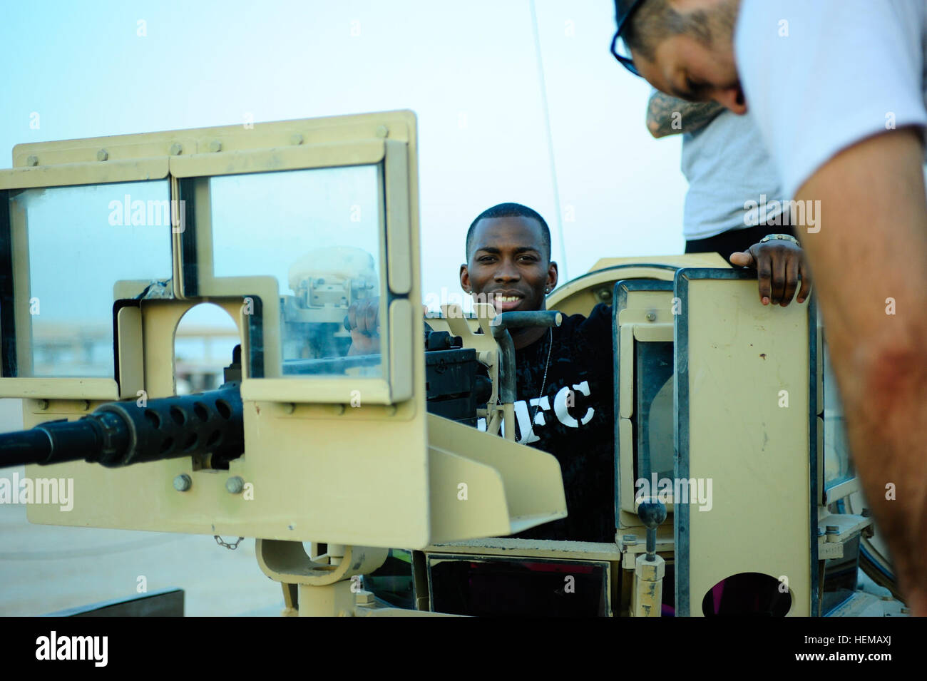 Ultimate Fighting Championship fighter Anthony 'The Assassin' Njokuani takes time to pose for a picture while in the hatch of an M1A2 Abrams tank Friday, at Camp Buehring, Kuwait. Soldiers of the 1st Battalion, 15th Infantry Regiment, 3rd Armored Brigade Combat Team, 3rd Infantry Division, introduced Njokauni, and other UFC members, to their combat vehicles during an Armed Forces Entertainment Tour. The Sledgehammer Brigade is currently deployed in support of U.S. Central Command's mission to provide peace and stability in the Middle East. Sledgehammer Brigade welcomes UFC stars 722696 Stock Photo