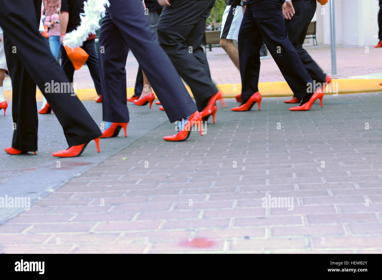Men in red highheel shoes march along the streets of El Paso, Oct. 16