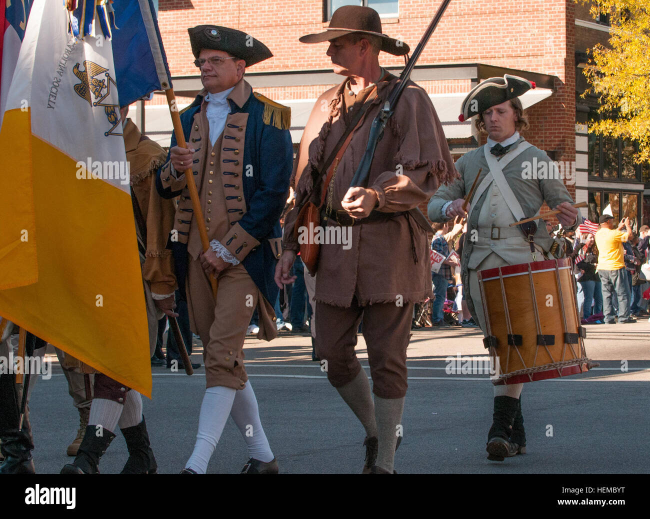 Chris Ruff, far right, keeps cadence on a drum for reenactors with the