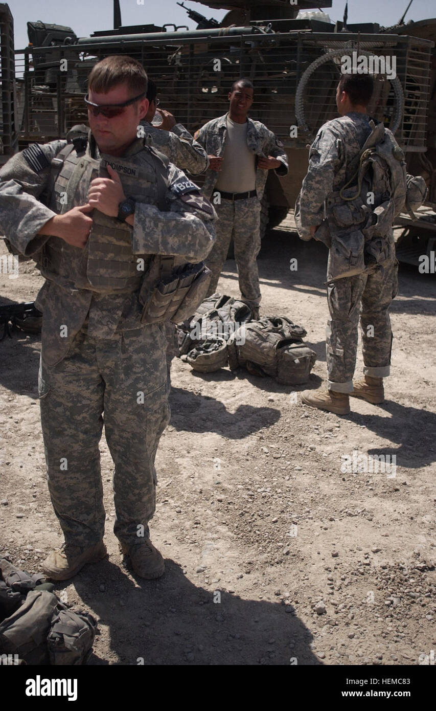 Staff Sgt. Jacob Thompson puts on his body armor in preparation for a mission in Baghdad, Iraq on May 22, 2007.Thompson is with Company B, 1st Battalion, 23rd Infantry Regiment, 3rd Stryker Brigade Combat Team, 2nd Infantry Division, Fort Lewis, Washington.  (US Army Photo by Spc. Elisha Dawkins) Stryker Brigade Mission 46029 Stock Photo