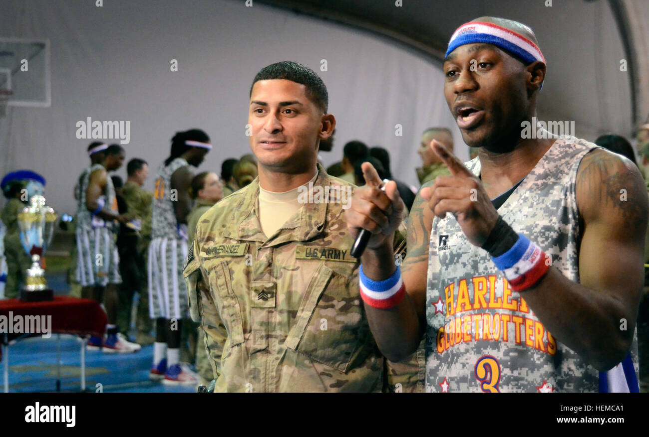 U.S. Army Sgt. Joriann Garcia-Hernandez with the 427th Brigade Support Company, New York Army National Guard from Syracuse, N.Y., reunites with his high school friend and now famous Harlem Globetrotter "Firefly" Fisher at Bagram Air Field, Afghanistan, Nov. 28, 2012. (U.S. Army photo by Staff Sgt. David J. Overson, 115th Mobile Public Affairs Detachment) Harlem Globetrotters bounce through Bagram 121128-A-RW508-005 Stock Photo