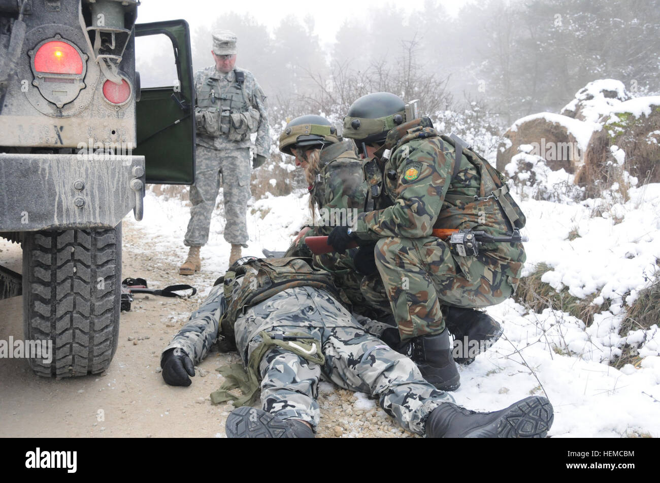 Bulgarian army soldiers (right) evaluate a simulated casualty while a