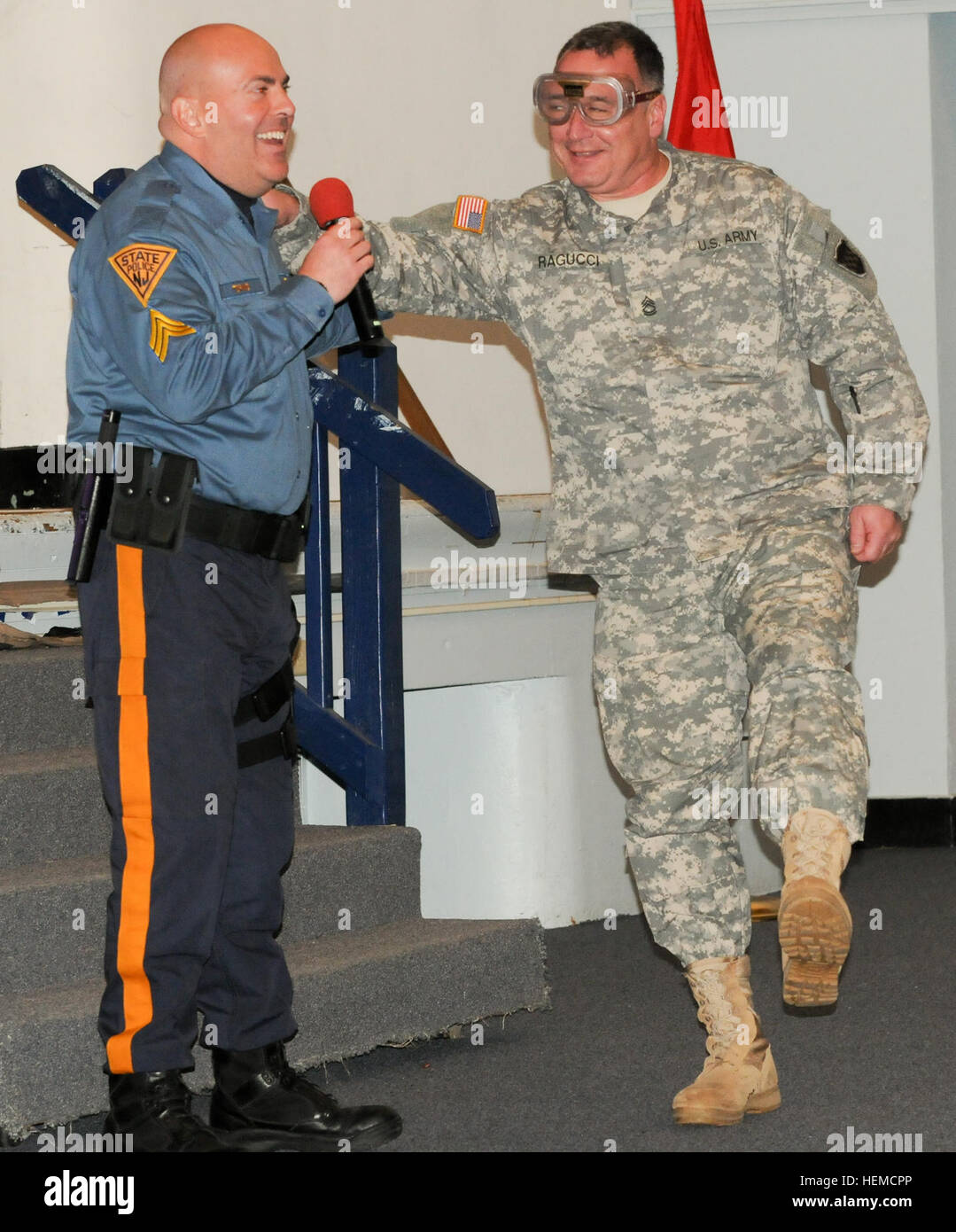 Sgt. 1st Class John Ragucci, 99th Regional Support Command, right, tries to walk a straight line for the N.J. State Police while wearing goggles that simulate being intoxicated with alcohol during a Safety Stand-Down Dec. 13 at Timmermann Conference Center on Joint Base McGuire-Dix-Lakehurst, N.J. The purpose of the event was to raise awareness regarding safety issues affecting military families and service members both on- and off-duty. Army puts safety first with Stand-Down event 121216-A-VX676-001 Stock Photo