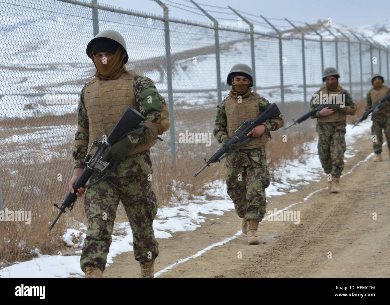 Afghan National Army soldiers dressed in protective equipment carry ...