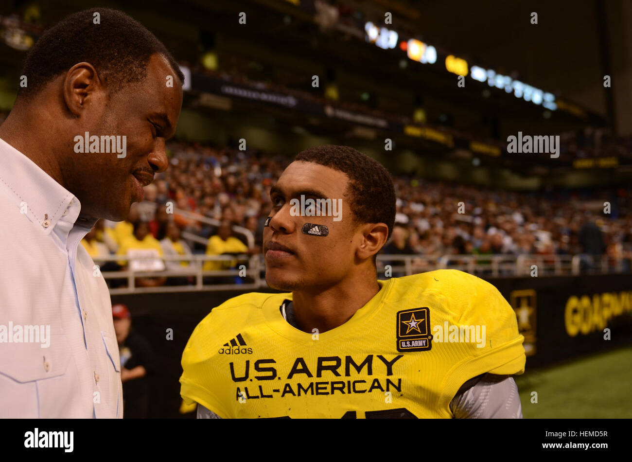 David Robinson, retired from the Spurs, speaks with his son, Corey Robinson, wide receiver for the West team, at the U.S. Army All-American Bowl at the Alamodome in San Antonio on Jan. 5, 2013. The U.S. Army All-American Bowl was sponsored by the U.S. Army. (U.S. Army Reserve photo by Pfc. Victor Blanco, 205th Public Affairs Operations Center) The Admiral and son 130105-A-GX635-429 Stock Photo