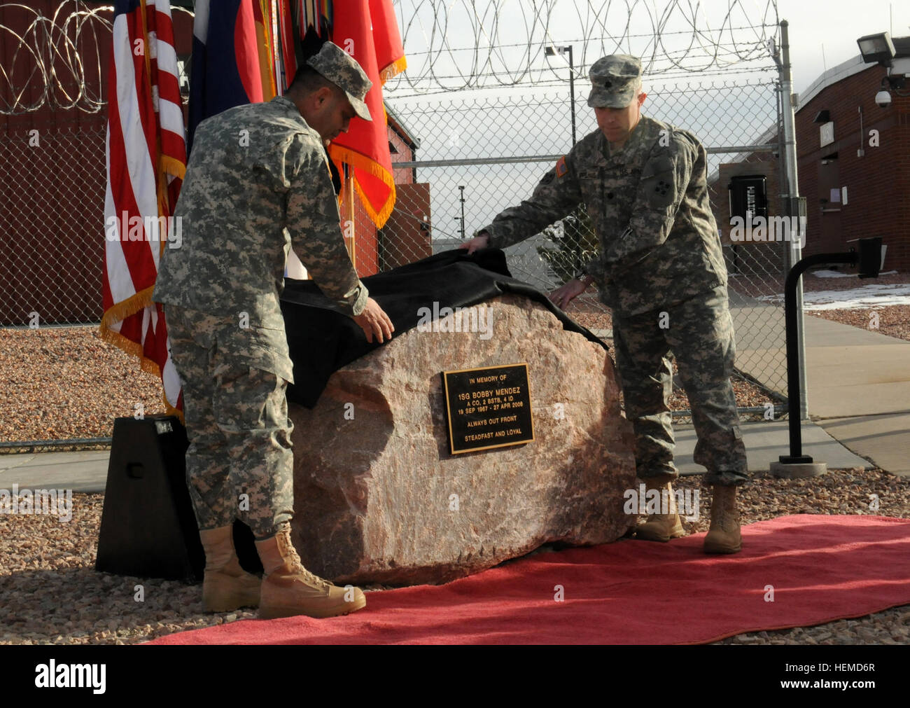Brig. Gen. Ryan Gonsalves, left, deputy commanding general - maneuver, 4th Infantry Division, and Lt. Col. Richard Appelhans, assistant chief of staff for Intelligence, 4th Infantry Division, unveil the memorial rock dedicating the Fort Carson Multi-disciplinary Training Platform to 1st Sgt. Bobby Mendez, Jan. 7, 2013. Mendez was killed April 27, 2006, in Baghdad, Iraq, when an improvised explosive device detonated near his Humvee during a combat operation. The facility, formerly known simply as the foundry, was renamed to 1st Sgt. Bobby Mendez Foundry Training Platform in his memory.  (U.S. A Stock Photo