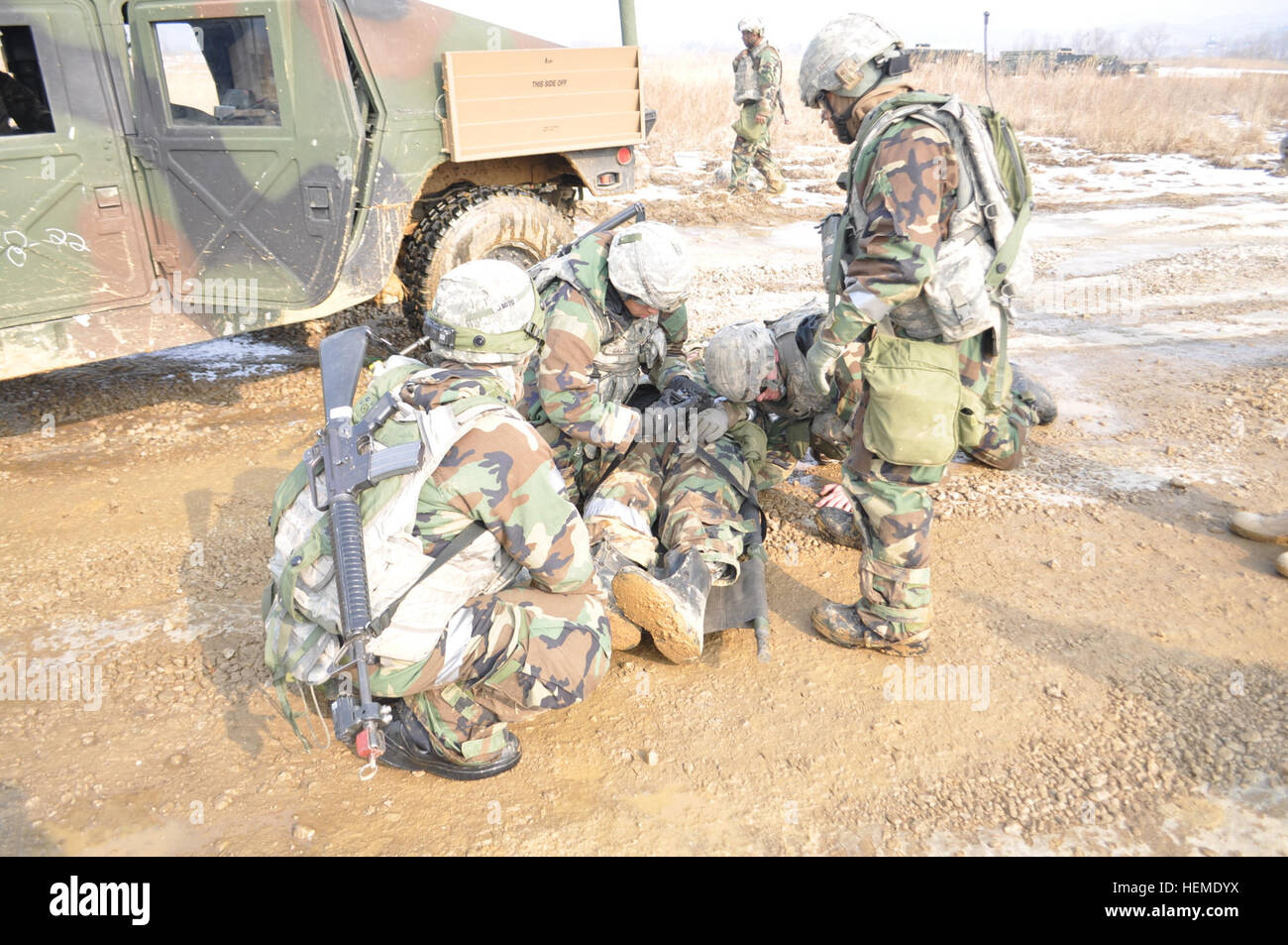 U.S. Soldiers assigned to the 6th Battalion, 37th Field Artillery Regiment, 210th Fires Brigade, 2nd Infantry Division, secure a simulated casualty to a litter during medical evacuation training in Gyeonggi province, South Korea, Jan. 31, 2013.  (U.S. Army photo by Pfc. Han-byeol Kim/Released) Medical evacuation training 130131-A-WG463-015 Stock Photo