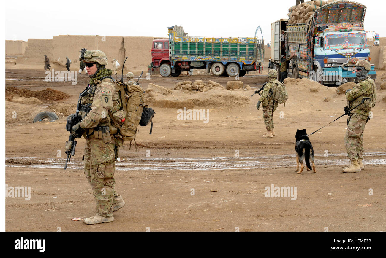 U.S. Army Soldiers with Security Force Assistance Team (SFAT) Liberty, conduct a check of the customs yard near the Afghanistan-Pakistan Border near Spin Boldak, Kandahar province, Afghanistan, Feb. 5, 2013. The SFAT team is comprised of Soldiers with the 56th Infantry Brigade Combat Team and Texas Army National Guard to work closely with the Afghan Border Police. (U.S. Army photo Staff Sgt. Shane Hamann/Released) Soldiers assess progress at border crossing 130205-A-MX357-143 Stock Photo