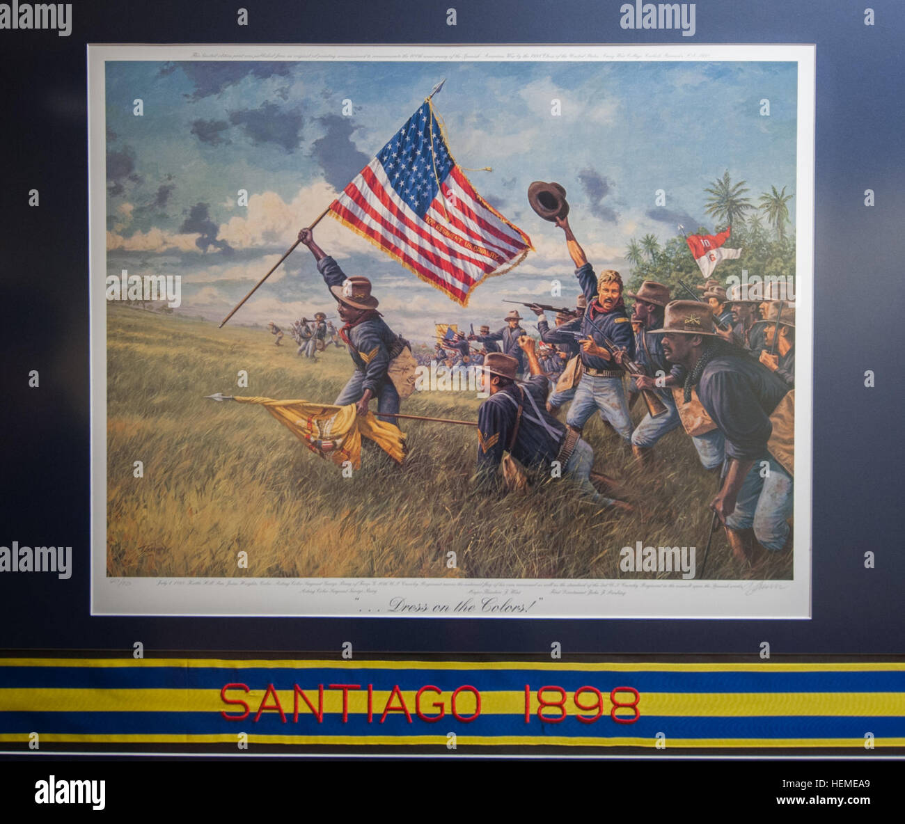 Buffalo Soldier prints, by famed historical artist Dale Gallon, hang in the U.S. Army Reserve Command Headquarters on Fort Bragg, N.C., Feb. 12, 2013. The prints, located on the first floor near the USARC G-4, are in commemoration of Black History month.  In this painting, acting Color Sergeant George Berry of Troop G, 10th U.S. Cavalry Regiment, carries the national flag of his own command as well as the standard of the 3rd U.S. Cavalry Regiment in the assault upon the Spanish works on Kettle Hill, San Juan Heights, Cuba, July 1, 1898. Buffalo soldiers highlighted in USARC display 130212-A-XN Stock Photo