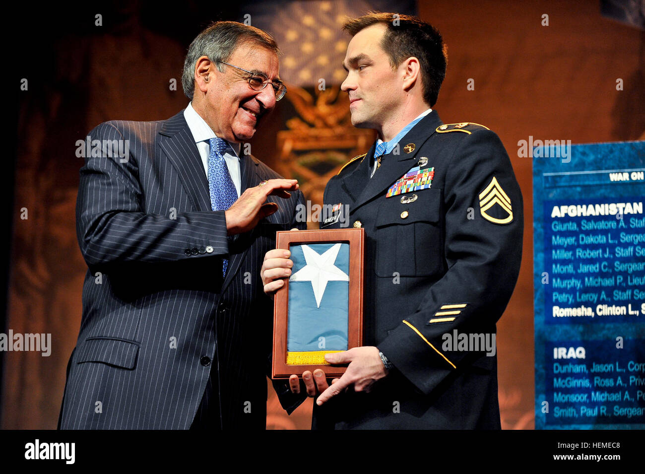 Secretary of Defense Leon E. Panetta presents former Army Staff Sgt. Clinton L. Romesha with the Medal of Honor Flag at the Pentagon, Feb. 11, 2013. (DoD Photo By Glenn Fawcett) (Released) Romesha with the Medal of Honor Flag at the Pentagon Stock Photo