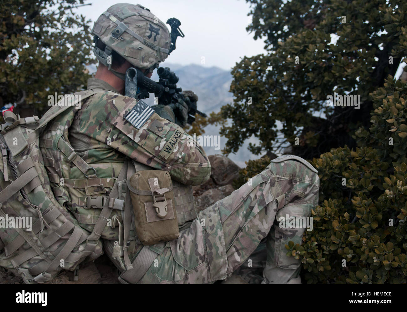 U.S. Army Pfc. Brandon Walker, a cavalry scout with the 3rd Platoon, Alpha Troop, 1st Squadron, 33rd Cavalry Regiment, 3rd Brigade, 101st Airborne Division (Air Assault), provides over-watch security on top of a mountain during a patrol in Paktya province, Afghanistan, Feb. 13, 2013. The platoon conducted a patrol to disrupt enemy positions near Combat Outpost Wilderness. (U.S. Army photo by Spc. Alex Kirk Amen/Released)eased) Rakkasans take the high ground 130213-A-NS855-005 Stock Photo