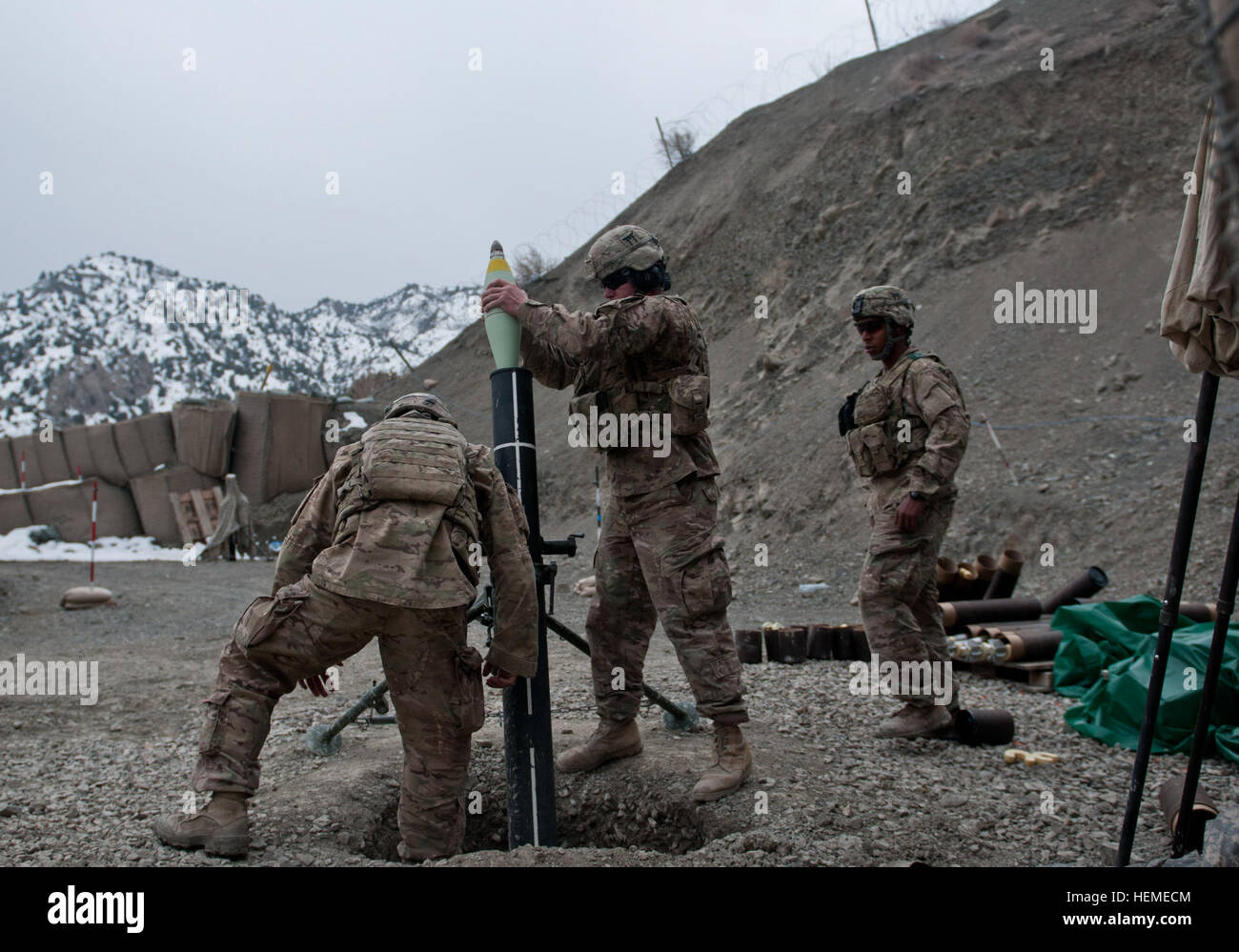 U.S. Army Pfc. Andrew Benis, center, with Alpha Troop, 1st Squadron, 33rd Cavalry Regiment, loads a 120 mm round into an M120 mortar system during live-fire training at Combat Outpost Wilderness near the Khost-Gardez Pass in Afghanistan, Feb. 13, 2013. The pass is the main land route connecting the Afghan province of Khost and Gardez, the capital of Paktia province.  (U.S. Army photo by Spc. Alex Amen/Released) Artillerymen, mortarmen train with live-fire missions 130213-A-NS855-009 Stock Photo