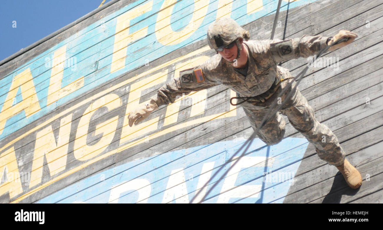 Sgt. Jeffrey Laursen, an air assault instructor with the Air Assault School at Fort Drum, N.Y., practices rappelling at the Air Assault Compound on Fort Polk, Tuesday. Laursen is repelling face down, this maneuver is called the Australian rappel. Air Assault, Patriot style 879709 Stock Photo