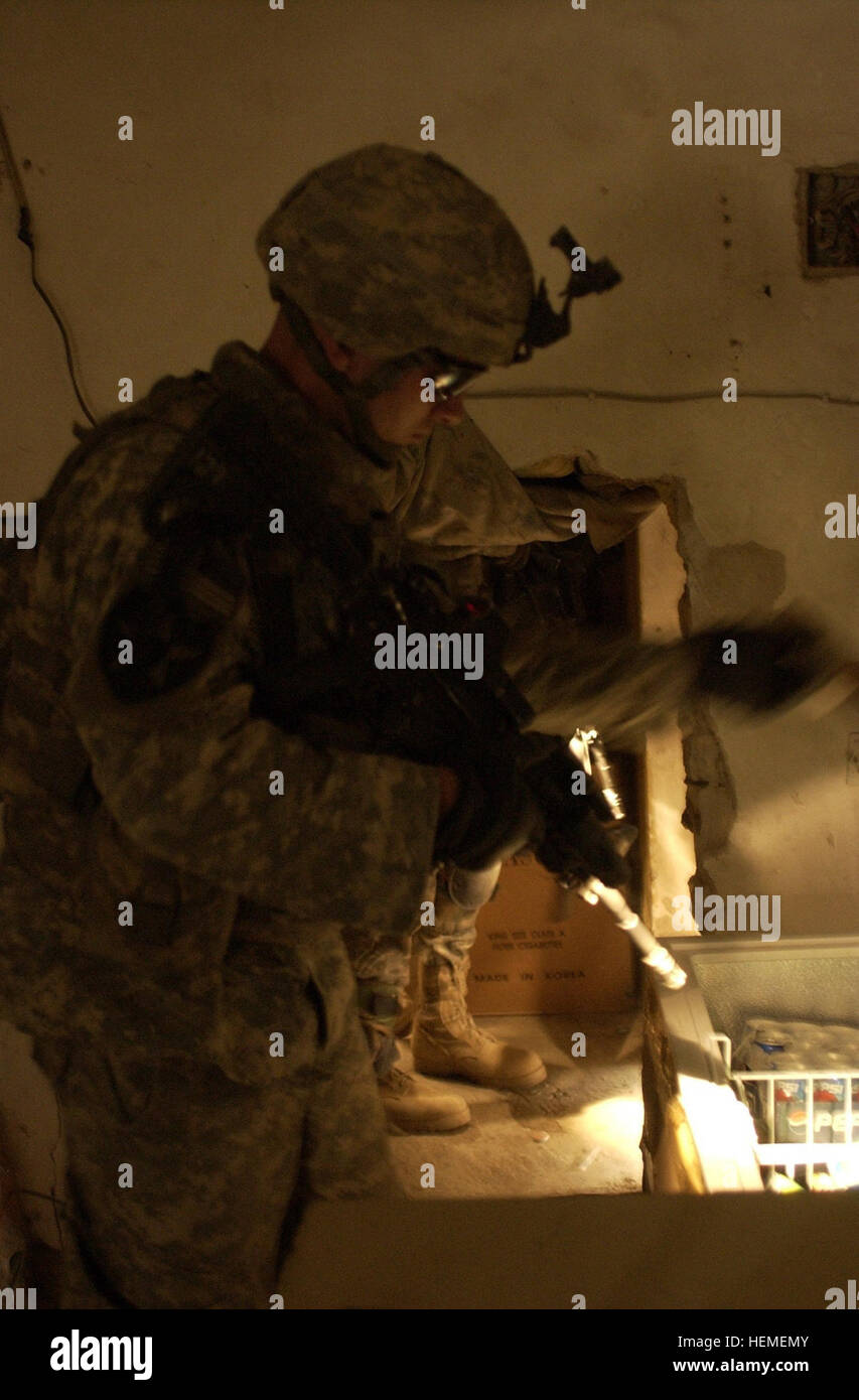 U.S. Army Soldiers look for explosive devices in Rashid, Iraq, June 20. The Soldiers are with 4th Platoon, C Company, 2nd Battalion, 3rd Infantry Regiment, 3rd Stryker Brigade Combat Team, 2nd Infantry Division out of Fort Lewis, Washington. Stryker Soldiers Cordon and Search, Protect Local Citizens 49144 Stock Photo