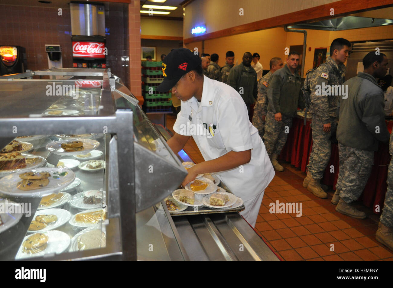 U.S. Army Pfc. Torronica Bell, left, a food service specialist assigned to Headquarters and Headquarters Company, 70th Brigade Support Battalion, 210th Fires Brigade, 2nd Infantry Division, arranges cookies and cakes in the Thunder Inn Dining Facility at Camp Casey in Dongducheon, South Korea, Feb. 21, 2013. (U.S. Army photo by Pfc. Kim Han-byeol/Released) Thunder Inn celebrates Black History Month 130221-A-WG463-012 Stock Photo