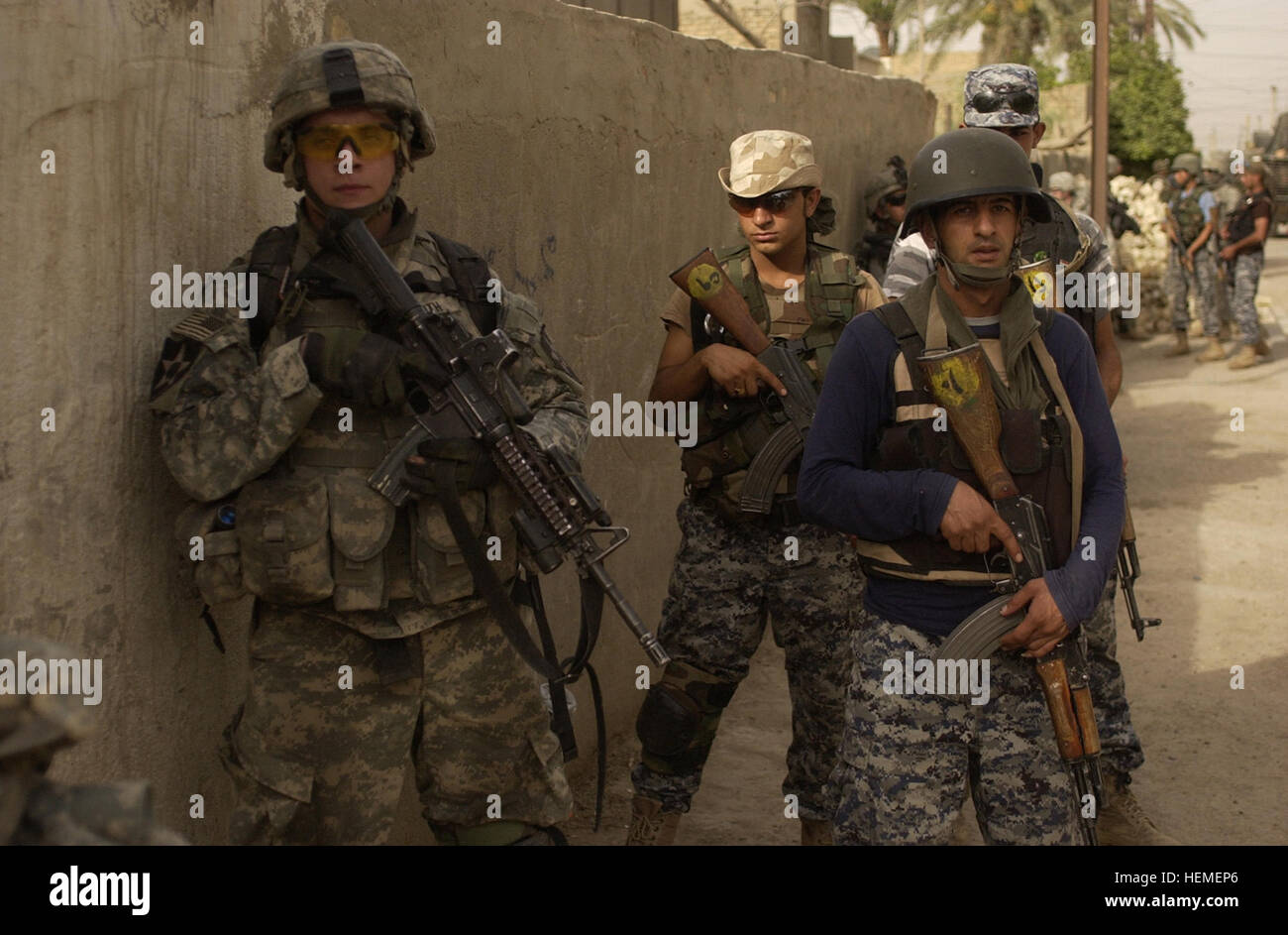 The Iraqi national police perform a joint cordon and search mission with U.S. Army Soldiers of 4th Platoon, Charlie Company, 2nd Battalion, 3rd Infantry Regiment, 3rd Stryker Brigade Combat Team, 2nd Infantry Division out of Fort Lewis, Washington in Rashid, Iraq, June 20. Stryker Soldiers Cordon and Search, Protect Local Citizens 49153 Stock Photo