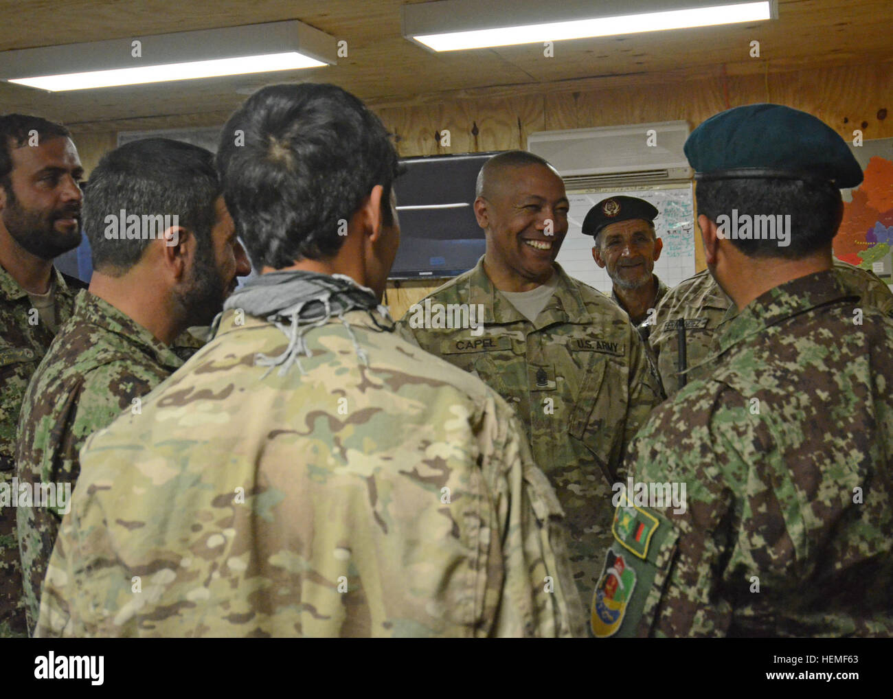 U.S. Army Command Sgt. Maj. Thomas R. Capel, center, International Security Assistance Force and United States Forces-Afghanistan, senior enlisted leader, shares a light moment with Afghan National Army soldiers assigned to 2nd Brigade, 201st Corps, at Forward Operating Base Joyce. During the battlefield circulation, Capel conducted a question and answer session with soldiers, met with senior leadership and toured the Afghan National Army side of the base. (U.S. Army photo by Staff Sgt. Richard Andrade, Task Force Long Knife Public Affairs) ISAF senior enlisted leader visits FOB Joyce 130302-A Stock Photo