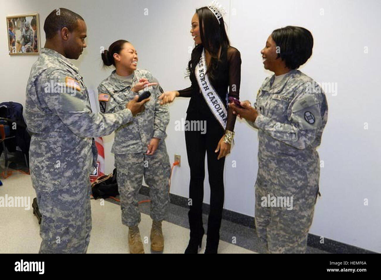 RALEIGH, N.C. -- Soldiers, Airmen and civilian staff at the North Carolina National Guard Joint Force headquarters enjoyed a Black history celebration by the United Service Organizations of North Carolina here, Feb 27.  Eugene Weeks, the Mayor Pro-tem of Raleigh acted as host.  He introduced motivational speaker retired Army Lt. Col. Terrance A. Garrick and Ashley Mills, Miss North Carolina USA 2013.  Mills posed for photos and signed autographs between fits of giggles and many smiles shared with the audience.   “It is an honor and privilege to show gratitude to our military,’ said Mills. (U.S Stock Photo